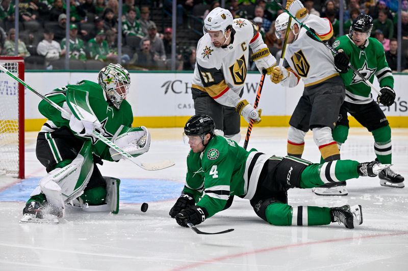 Dec 9, 2023; Dallas, Texas, USA; Vegas Golden Knights right wing Mark Stone (61) and Dallas Stars goaltender Jake Oettinger (29) and defenseman Miro Heiskanen (4) battle for control of the loose puck in the Stars zone during the third period at the American Airlines Center. Mandatory Credit: Jerome Miron-USA TODAY Sports