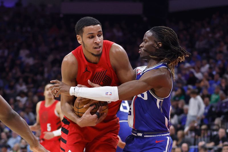 SACRAMENTO, CALIFORNIA - APRIL 14: Kris Murray #8 of the Portland Trail Blazers is guarded by Keon Ellis #23 of the Sacramento Kings in the third quarter at Golden 1 Center on April 14, 2024 in Sacramento, California. NOTE TO USER: User expressly acknowledges and agrees that, by downloading and or using this photograph, User is consenting to the terms and conditions of the Getty Images License Agreement. (Photo by Lachlan Cunningham/Getty Images)