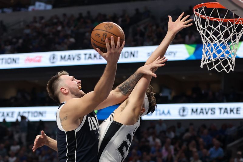 DALLAS, TEXAS - OCTOBER 24: Luka Doncic #77 of the Dallas Mavericks drives against Zach Collins #23 of the San Antonio Spurs during the second quarter at American Airlines Center on October 24, 2024 in Dallas, Texas.  NOTE TO USER: User expressly acknowledges and agrees that, by downloading and or using this photograph, User is consenting to the terms and conditions of the Getty Images License Agreement. (Photo by Sam Hodde/Getty Images)