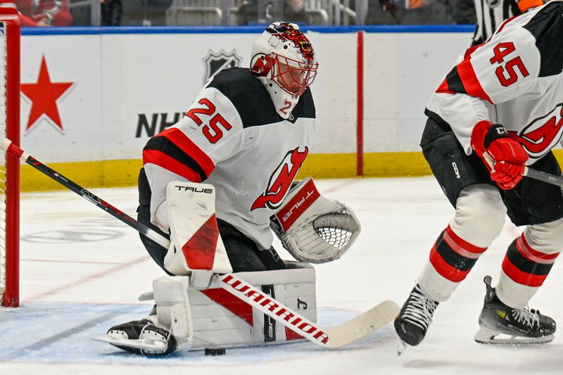 Dec 23, 2025; Elmont, New York, USA;  New Jersey Devils goaltender Jacob Markstrom (25) makes a save against the New York Islanders during the second period at UBS Arena. Mandatory Credit: Dennis Schneidler-Imagn Images