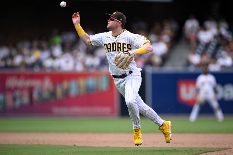 Aug 19, 2023; San Diego, California, USA; San Diego Padres second baseman Jake Cronenworth (9) cannot handle the ball on a single hit by Arizona Diamondbacks center fielder Alek Thomas (not pictured) during the sixth inning at Petco Park. Mandatory Credit: Orlando Ramirez-USA TODAY Sports