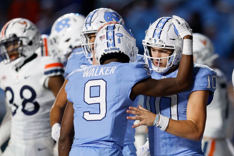 Oct 21, 2023; Chapel Hill, North Carolina, USA; North Carolina Tar Heels quarterback Drake Maye (10) hugs wide receiver Devontez Walker (9) after a touchdown against the North Carolina Tar Heels in the second half at Kenan Memorial Stadium. Mandatory Credit: Nell Redmond-USA TODAY Sports