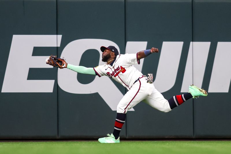 May 12, 2025; Atlanta, Georgia, USA; Atlanta Braves center fielder Michael Harris II (23) attempts to make a catch against the Washington Nationals in the eighth inning at Truist Park. Mandatory Credit: Brett Davis-Imagn Images
