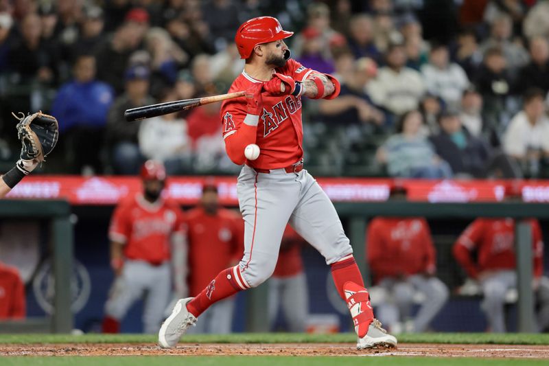 Jun 2, 2024; Seattle, Washington, USA;  Los Angeles Angels left fielder Kevin Pillar (12) is hit by a pitch against the Seattle Mariners during the second inning at T-Mobile Park. Mandatory Credit: John Froschauer-USA TODAY Sports