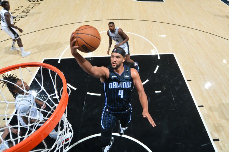 SAN ANTONIO, TX - OCTOBER 9: Jalen Suggs #4 of the Orlando Magic shoots the ball during the game against the San Antonio Spurs during a NBA preseason game on October 9, 2024 at the Frost Bank Center in San Antonio, Texas. NOTE TO USER: User expressly acknowledges and agrees that, by downloading and or using this photograph, user is consenting to the terms and conditions of the Getty Images License Agreement. Mandatory Copyright Notice: Copyright 2024 NBAE (Photos by Michael Gonzales/NBAE via Getty Images)