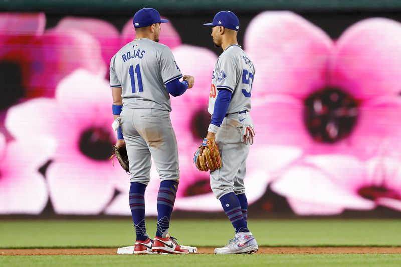 Apr 23, 2024; Washington, District of Columbia, USA; Los Angeles Dodgers shortstop Miguel Rojas (11) talks with Dodgers shortstop Mookie Betts (50) after their game against the Washington Nationals at Nationals Park. Mandatory Credit: Geoff Burke-USA TODAY Sports