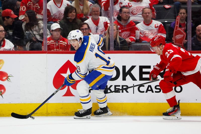 Mar 16, 2024; Detroit, Michigan, USA;  Buffalo Sabres center Peyton Krebs (19) skates with the puck chased by Detroit Red Wings left wing Lucas Raymond (23) in the second period at Little Caesars Arena. Mandatory Credit: Rick Osentoski-USA TODAY Sports