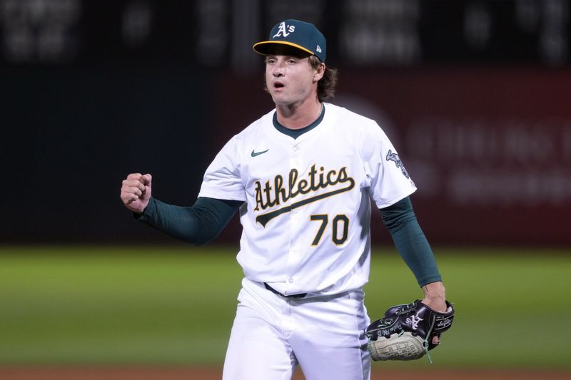 Aug 21, 2024; Oakland, California, USA; Oakland Athletics relief pitcher J.T. Ginn (70) reacts after striking out the side in his MLB debut against the Tampa Bay Rays /during the eighth inning at Oakland-Alameda County Coliseum. Mandatory Credit: Darren Yamashita-USA TODAY Sports