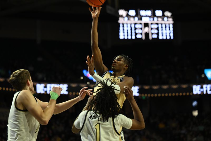 Feb 11, 2023; Winston-Salem, North Carolina, USA; Georgia Tech Yellow Jackets guard Miles Kelly (13) shoots the ball against Wake Forest Demon Deacons guard Tyree Appleby (1) and forward Andrew Carr (11) during the second half at Lawrence Joel Veterans Memorial Coliseum. Mandatory Credit: William Howard-USA TODAY Sports