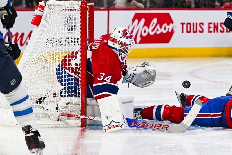 Oct 28, 2023; Montreal, Quebec, CAN; Montreal Canadiens goalie Jake Allen (34) makes a save against the Winnipeg Jets during the third period at Bell Centre. Mandatory Credit: David Kirouac-USA TODAY Sports