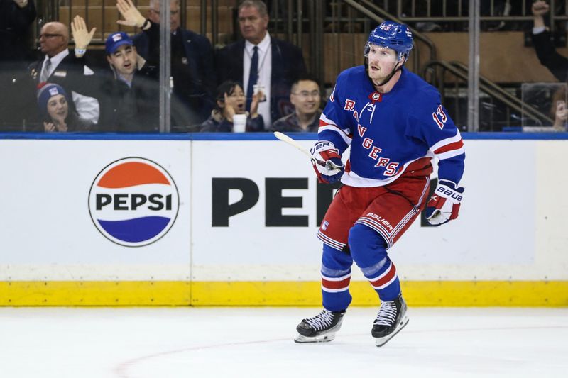 Nov 12, 2023; New York, New York, USA; New York Rangers left wing Alexis Lafreniere (13) scores the game winning goal in a shootout against the Columbus Blue Jackets at Madison Square Garden. Mandatory Credit: Wendell Cruz-USA TODAY Sports