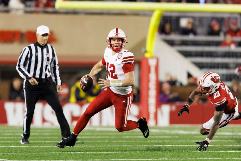 Nov 18, 2023; Madison, Wisconsin, USA;  Nebraska Cornhuskers quarterback Chubba Purdy (12) rushes with the football before scoring a touchdown during the first quarter against the Wisconsin Badgers at Camp Randall Stadium. Mandatory Credit: Jeff Hanisch-USA TODAY Sports