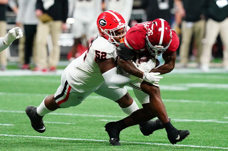 Dec 2, 2023; Atlanta, GA, USA; Georgia Bulldogs defensive lineman Christen Miller (52) tackles Alabama Crimson Tide running back Jam Miller (26) in the first quarter of the SEC Championship at Mercedes-Benz Stadium. Mandatory Credit: John David Mercer-USA TODAY Sports