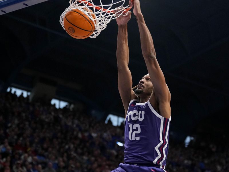 Jan 6, 2024; Lawrence, Kansas, USA; TCU Horned Frogs forward Xavier Cork (12) dunks the ball against the Kansas Jayhawks during the first half at Allen Fieldhouse. Mandatory Credit: Jay Biggerstaff-USA TODAY Sports