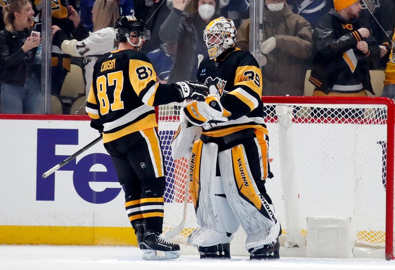 Apr 6, 2024; Pittsburgh, Pennsylvania, USA;  Pittsburgh Penguins center Sidney Crosby (87) and goaltender Alex Nedeljkovic (39) celebrate after defeating the Tampa Bay Lightning at PPG Paints Arena. The Penguins won 5-4. Mandatory Credit: Charles LeClaire-USA TODAY Sports