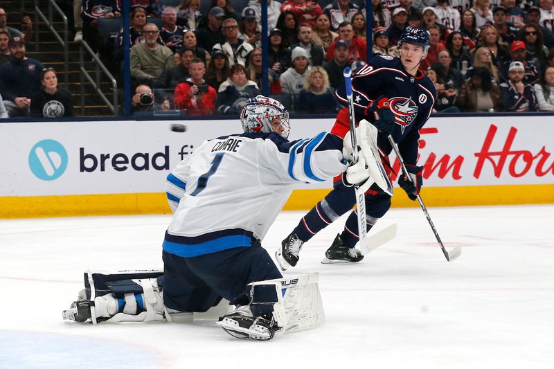 Nov 1, 2024; Columbus, Ohio, USA; Winnipeg Jets goalie Eric Comrie (1) makes a save against the Columbus Blue Jackets during the second period at Nationwide Arena. Mandatory Credit: Russell LaBounty-Imagn Images