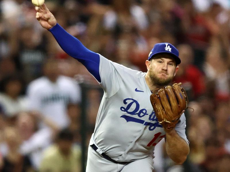 Oct 11, 2023; Phoenix, Arizona, USA; Los Angeles Dodgers third baseman Max Muncy (13) makes a throw to first base against the Arizona Diamondbacks in the second inning for game three of the NLDS for the 2023 MLB playoffs at Chase Field. Mandatory Credit: Mark J. Rebilas-USA TODAY Sports