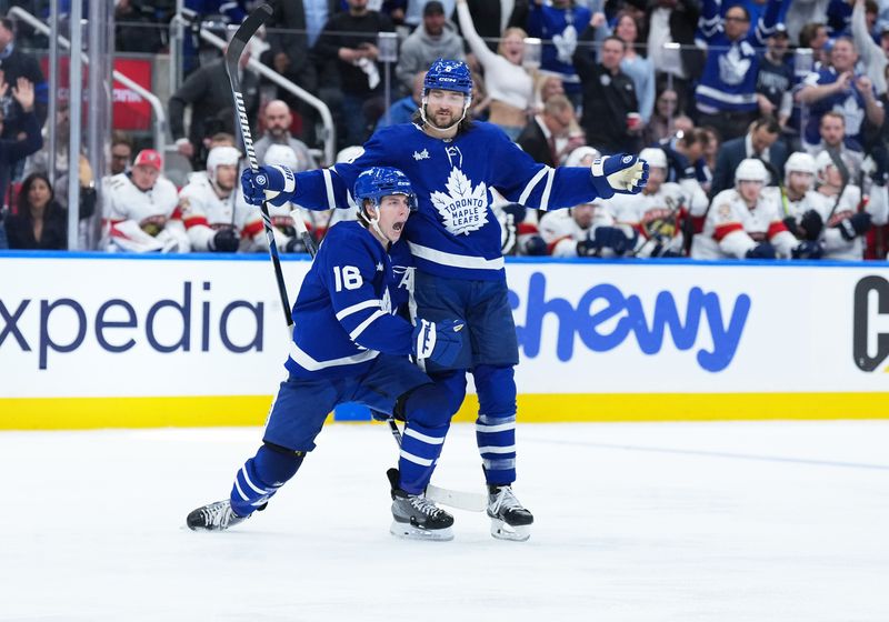 May 7, 2025; Toronto, Ontario, CAN; Toronto Maple Leafs right wing Mitch Marner (16) scores a goal and celebrates with defenseman Chris Tanev (8) against the Florida Panthers during the third period in game two of the second round of the 2025 Stanley Cup Playoffs at Scotiabank Arena. Mandatory Credit: Nick Turchiaro-Imagn Images