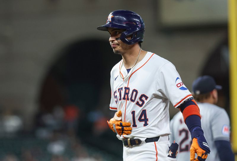 May 2, 2024; Houston, Texas, USA; Houston Astros left fielder Mauricio Dubon (14) reacts after hitting a single during the third inning against the Cleveland Guardians at Minute Maid Park. Mandatory Credit: Troy Taormina-USA TODAY Sports