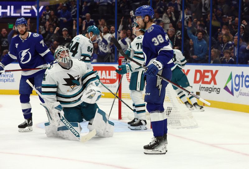 Dec 5, 2024; Tampa, Florida, USA; Tampa Bay Lightning left wing Brandon Hagel (38) scores a goal on San Jose Sharks goaltender Vitek Vanecek (41) during the first period at Amalie Arena. Mandatory Credit: Kim Klement Neitzel-Imagn Images