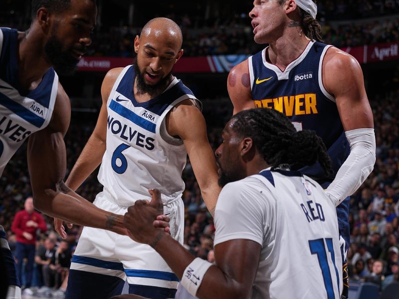 DENVER, CO - APRIL 10: Naz Reid #11 of the Minnesota Timberwolves is helped up by teammates Jordan McLaughlin #6 and Mike Conley #10 and by opponent Aaron Gordon #50 of the Denver Nuggets during the game on April 10, 2024 at the Ball Arena in Denver, Colorado. NOTE TO USER: User expressly acknowledges and agrees that, by downloading and/or using this Photograph, user is consenting to the terms and conditions of the Getty Images License Agreement. Mandatory Copyright Notice: Copyright 2024 NBAE (Photo by Bart Young/NBAE via Getty Images)