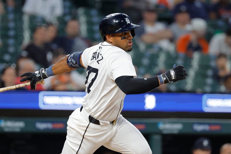 May 13, 2024; Detroit, Michigan, USA;  Detroit Tigers second base Andy Ibáñez (77) hits an RBI single in the eighth inning against the Miami Marlins at Comerica Park. Mandatory Credit: Rick Osentoski-USA TODAY Sports