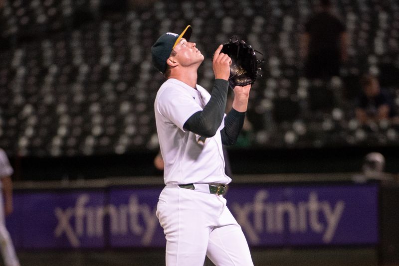 Jul 2, 2024; Oakland, California, USA; Oakland Athletics pitcher Mason Miller (19) points to the sky after making the final out against the Los Angeles Angels at Oakland-Alameda County Coliseum. Mandatory Credit: Ed Szczepanski-USA TODAY Sports