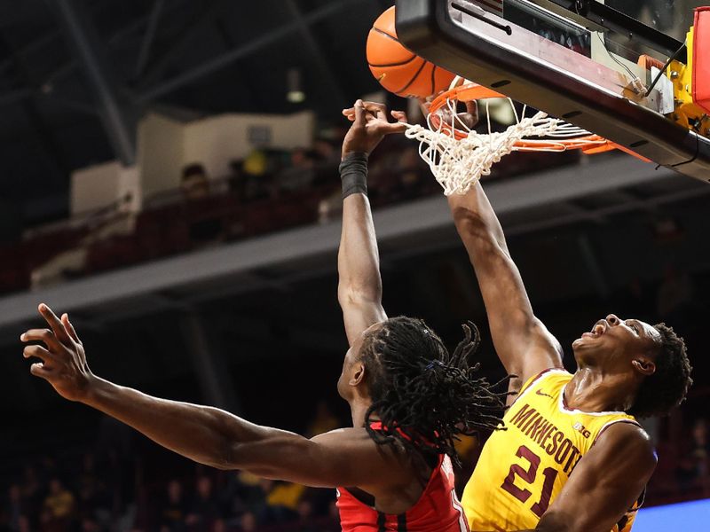 Mar 2, 2023; Minneapolis, Minnesota, USA; Rutgers Scarlet Knights center Clifford Omoruyi (11) blocks a shot by Minnesota Golden Gophers forward Pharrel Payne (21) during the first half at Williams Arena. Mandatory Credit: Matt Krohn-USA TODAY Sports