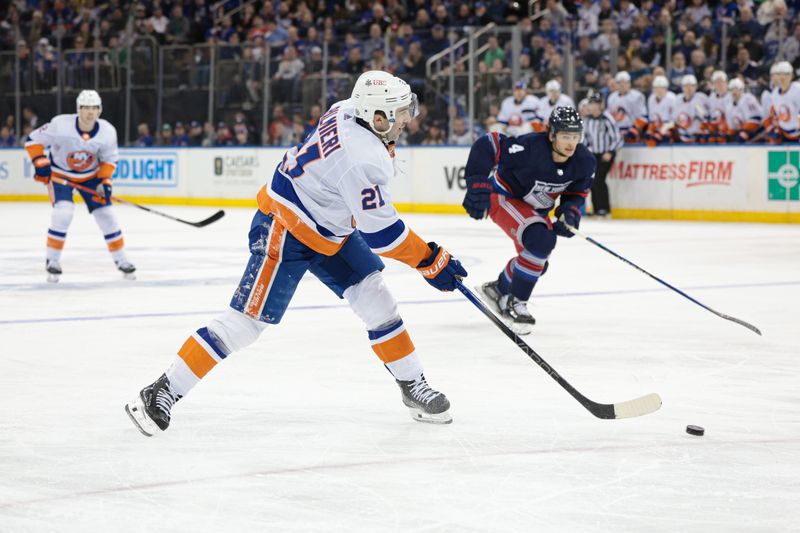 Mar 17, 2024; New York, New York, USA; New York Islanders center Kyle Palmieri (21) shoots the puck in front of New York Rangers defenseman Braden Schneider (4) during the first period at Madison Square Garden. Mandatory Credit: Vincent Carchietta-USA TODAY Sports