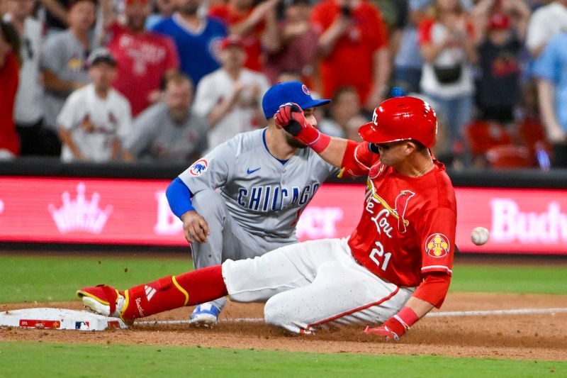 May 25, 2024; St. Louis, Missouri, USA;  St. Louis Cardinals right fielder Lars Nootbaar (21) slides in at third after hitting a one run triple against the Chicago Cubs during the eighth inning at Busch Stadium. Mandatory Credit: Jeff Curry-USA TODAY Sports