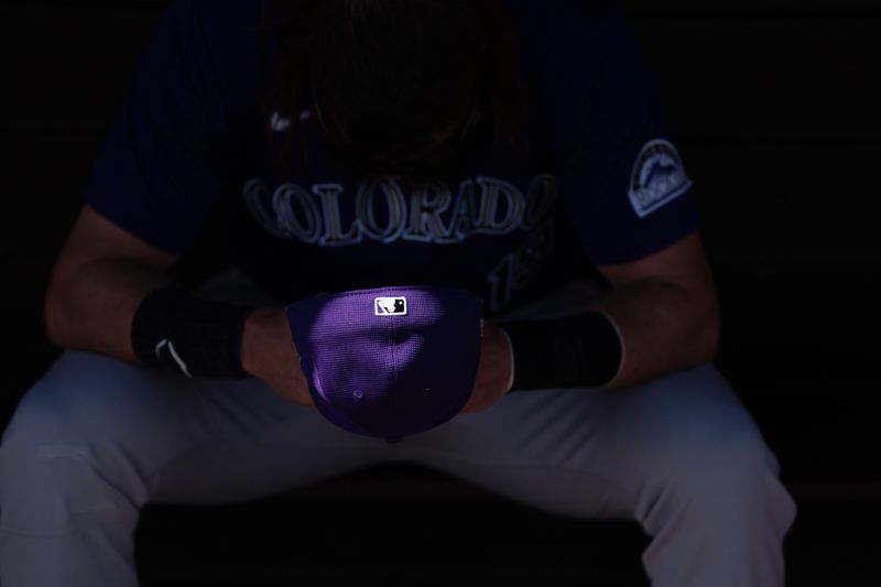 Mar 8, 2024; Tempe, Arizona, USA; Colorado Rockies designated hitter Charlie Blackmon (19) sits alone in the dugout before the start of a spring training game against the Los Angeles Angels at Tempe Diablo Stadium. Mandatory Credit: Allan Henry-USA TODAY Sports