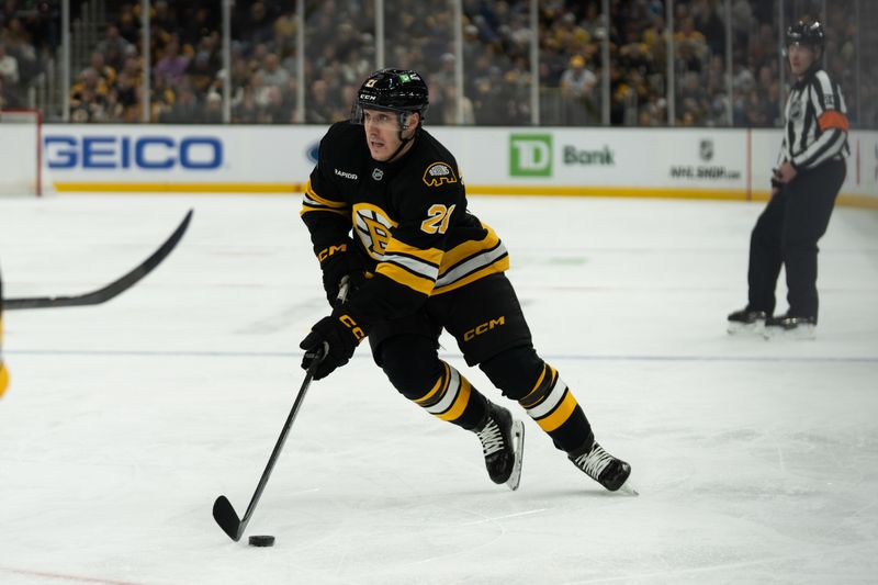 Jan 11, 2026; Boston, Massachusetts, USA; Boston Bruins center Alex Steeves (21) skates with the puck during the first period of the game against the Pittsburgh Penguins at TD Garden. Mandatory Credit: Natalie Reid-Imagn Images