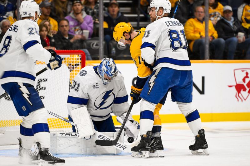 Nov 29, 2024; Nashville, Tennessee, USA;  Tampa Bay Lightning goaltender Jonas Johansson (31) blocks the shot of Nashville Predators center Gustav Nyquist (14) during the second period at Bridgestone Arena. Mandatory Credit: Steve Roberts-Imagn Images