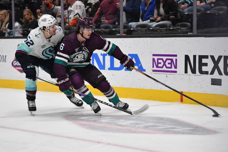 Dec 23, 2023; Anaheim, California, USA; Anaheim Ducks defenseman Jamie Drysdale (6) moves the puck against Seattle Kraken left wing Tye Kartye (52) during the first period at Honda Center. Mandatory Credit: Gary A. Vasquez-USA TODAY Sports