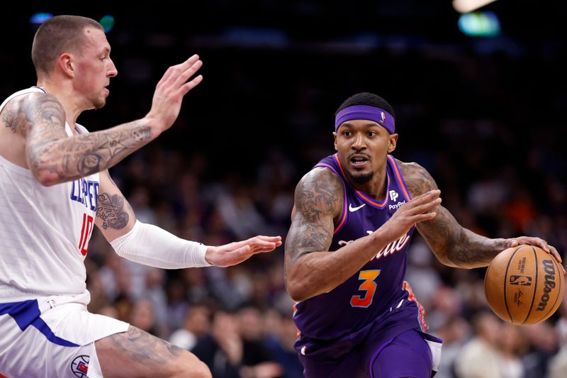 PHOENIX, ARIZONA - JANUARY 03: Bradley Beal #3 of the Phoenix Suns drives to the basket against Daniel Theis #10 of the Los Angeles Clippers during the first half at Footprint Center on January 03, 2024 in Phoenix, Arizona. NOTE TO USER: User expressly acknowledges and agrees that, by downloading and or using this photograph, User is consenting to the terms and conditions of the Getty Images License Agreement.  (Photo by Chris Coduto/Getty Images)