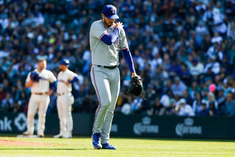 Oct 1, 2023; Seattle, Washington, USA; Texas Rangers starting pitcher Dane Dunning (33) walks to the dugout after being relieved for during the fourth inning against the Seattle Mariners at T-Mobile Park. Mandatory Credit: Joe Nicholson-USA TODAY Sports