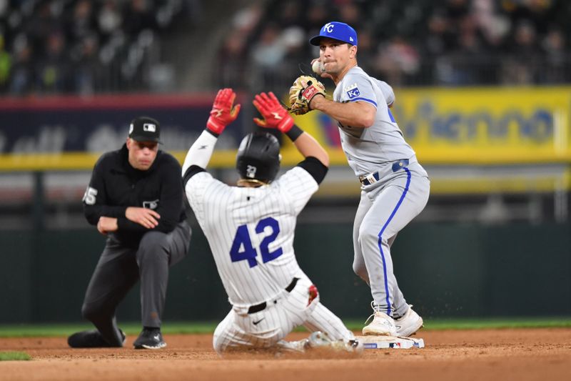 Apr 15, 2024; Chicago, Illinois, USA; Kansas City Royals second baseman Adam Frazier (26) completes a double play after forcing out Chicago White Sox left fielder Andrew Benintendi (23) during the sixth inning at Guaranteed Rate Field. Mandatory Credit: Patrick Gorski-USA TODAY Sports