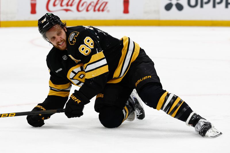 Oct 25, 2025; Boston, Massachusetts, USA; Boston Bruins right wing David Pastrnak (88) gets up from the ice after being knocked down during the second period against the Colorado Avalanche at TD Garden. Mandatory Credit: Winslow Townson-Imagn Images