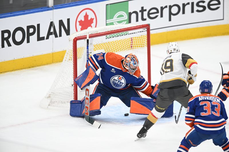 May 10, 2025; Edmonton, Alberta, CAN : Edmonton Oilers goalie Stuart Skinner (74) looks for the puck as Las Vegas Golden Knights  right winger Reilly Smith (19) shoots the puck towards him during the first period in game three of the second round of the 2025 Stanley Cup Playoffs at Rogers Place. Mandatory Credit: Walter Tychnowicz-Imagn Images