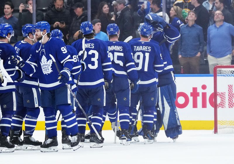 Nov 5, 2024; Toronto, Ontario, CAN; Toronto Maple Leafs goaltender Anthony Stolarz (41) celebrates the shoutout win with center John Tavares (91) against the Boston Bruins at the end of  the third period at Scotiabank Arena. Mandatory Credit: Nick Turchiaro-Imagn Imagess