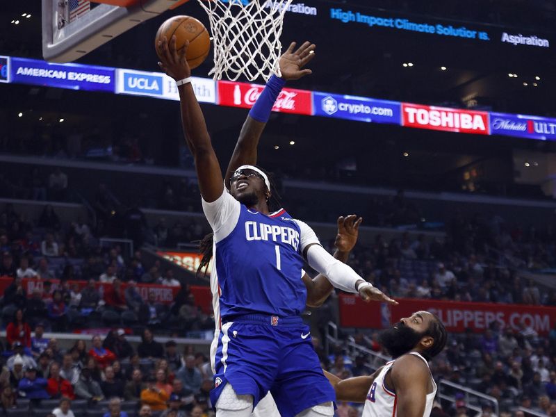 LOS ANGELES, CALIFORNIA - JANUARY 17:  Reggie Jackson #1 of the LA Clippers takes a shot against James Harden #1 and Montrezl Harrell #5 of the Philadelphia 76ers in the first half at Crypto.com Arena on January 17, 2023 in Los Angeles, California.  NOTE TO USER: User expressly acknowledges and agrees that, by downloading and/or using this photograph, user is consenting to the terms and conditions of the Getty Images License Agreement.  (Photo by Ronald Martinez/Getty Images)