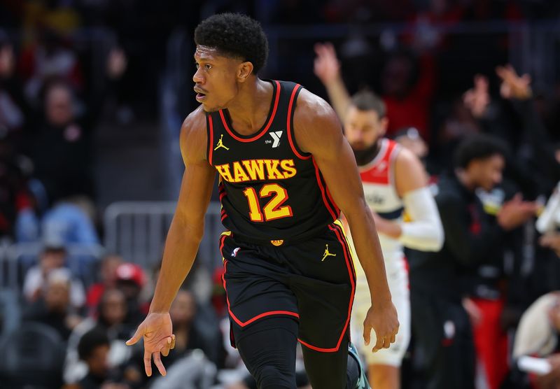 ATLANTA, GEORGIA - NOVEMBER 15:  De'Andre Hunter #12 of the Atlanta Hawks reacts after hitting a three-point basket against the Washington Wizards during the first quarter of the Emirates NBA Cup game at State Farm Arena on November 15, 2024 in Atlanta, Georgia.  NOTE TO USER: User expressly acknowledges and agrees that, by downloading and/or using this photograph, user is consenting to the terms and conditions of the Getty Images License Agreement.  (Photo by Kevin C. Cox/Getty Images)