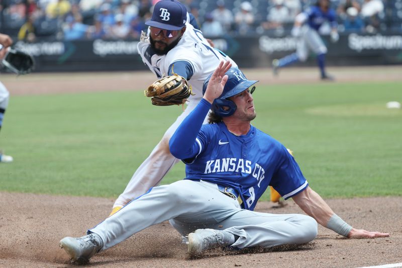 May 1, 2025; St. Petersburg, Florida, USA;  Kansas City Royals outfielder Drew Waters (8) slides into third base as Tampa Bay Rays third base Junior Caminero (13) tags him out during the third inning at George M. Steinbrenner Field. Mandatory Credit: Kim Klement Neitzel-Imagn Images