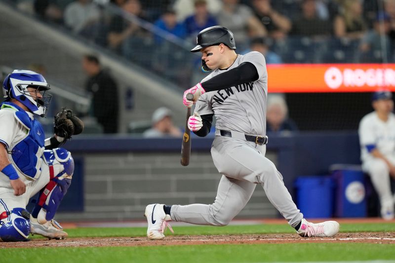 Jun 27, 2024; Toronto, Ontario, CAN; New York Yankees left fielder Alex Verdugo (24) looks back at the ball in the glove of Toronto Blue Jays catcher Alejandro Kirk (30) after striking out during the eighth inning at Rogers Centre. Mandatory Credit: John E. Sokolowski-USA TODAY Sports