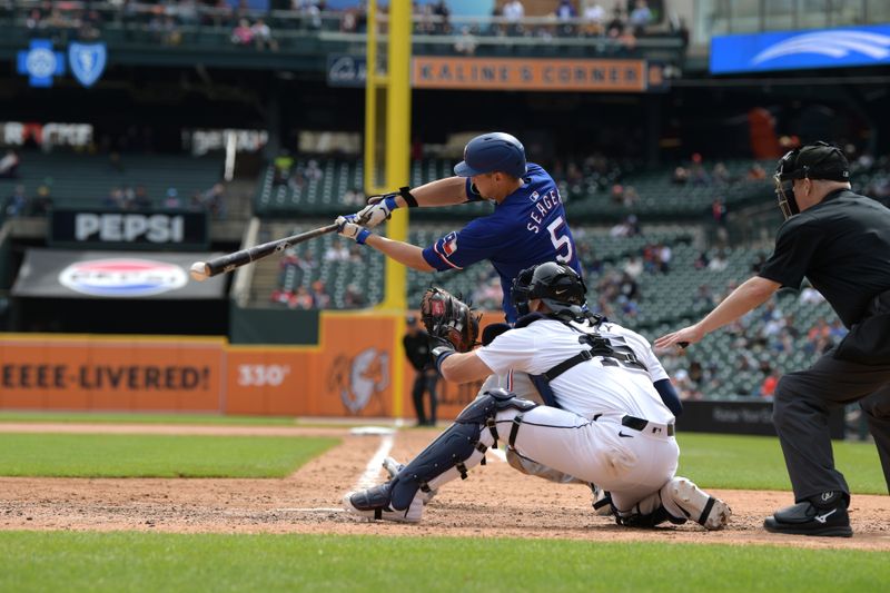 Apr 18, 2024; Detroit, Michigan, USA;  Texas Rangers shortstop Corey Seager (5) hits a single against the Detroit Tigers in the sixth inning at Comerica Park. Mandatory Credit: Lon Horwedel-USA TODAY Sports