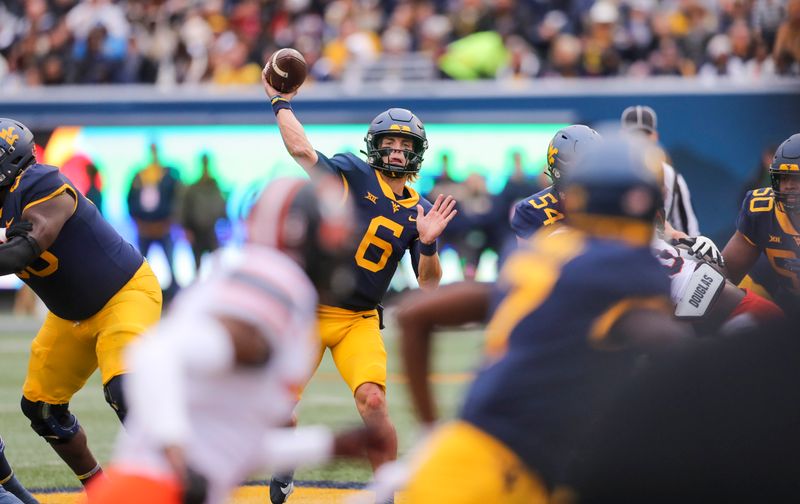 Oct 21, 2023; Morgantown, West Virginia, USA; West Virginia Mountaineers quarterback Garrett Greene (6) passes the ball against the Oklahoma State Cowboys during the second quarter at Mountaineer Field at Milan Puskar Stadium. Mandatory Credit: Ben Queen-USA TODAY Sports