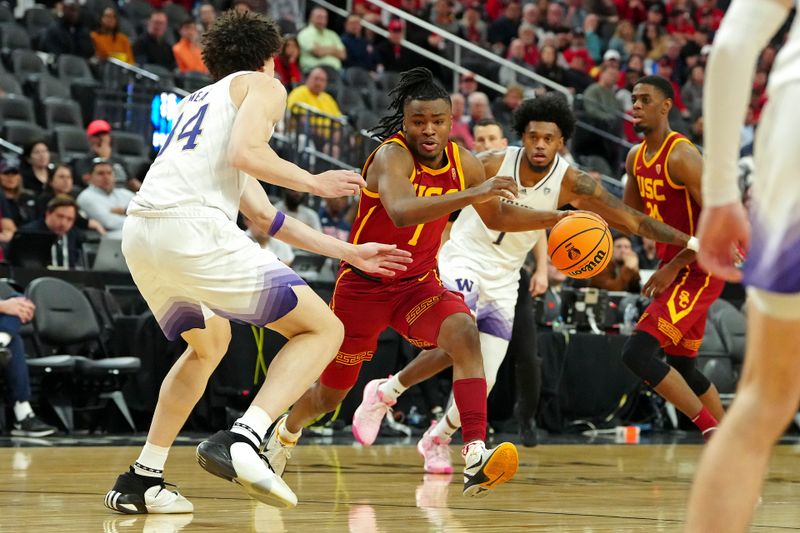 Mar 13, 2024; Las Vegas, NV, USA; USC Trojans guard Isaiah Collier (1) dribbles between Washington Huskies center Braxton Meah (34) and forward Keion Brooks Jr. (1) during the second half at T-Mobile Arena. Mandatory Credit: Stephen R. Sylvanie-USA TODAY Sports