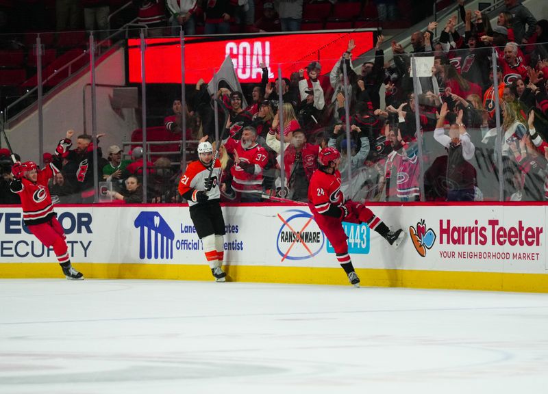 Mar 21, 2024; Raleigh, North Carolina, USA; Carolina Hurricanes center Seth Jarvis (24) celebrates his game winner in the overtime against the Philadelphia Flyers at PNC Arena. Mandatory Credit: James Guillory-USA TODAY Sports