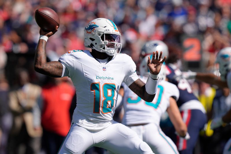 Miami Dolphins quarterback Tyler Huntley (18) throws a pass against the New England Patriots during the first half of an NFL football game, Sunday, Oct. 6, 2024, in Foxborough, Mass. (AP Photo/Steven Senne)