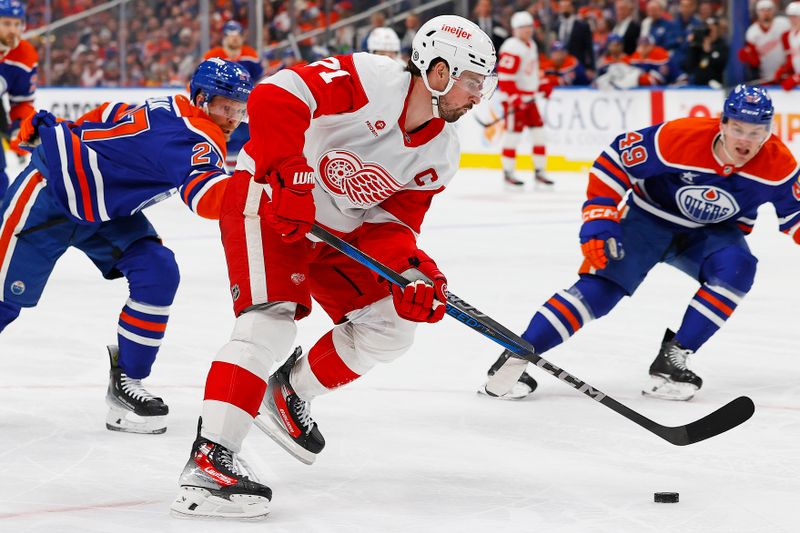 Jan 30, 2025; Edmonton, Alberta, CAN; Detroit Red Wings forward Dylan Larkin (71) carries the puck around Edmonton Oilers defensemen Brett Kulak (27) during the second period at Rogers Place. Mandatory Credit: Perry Nelson-Imagn Images